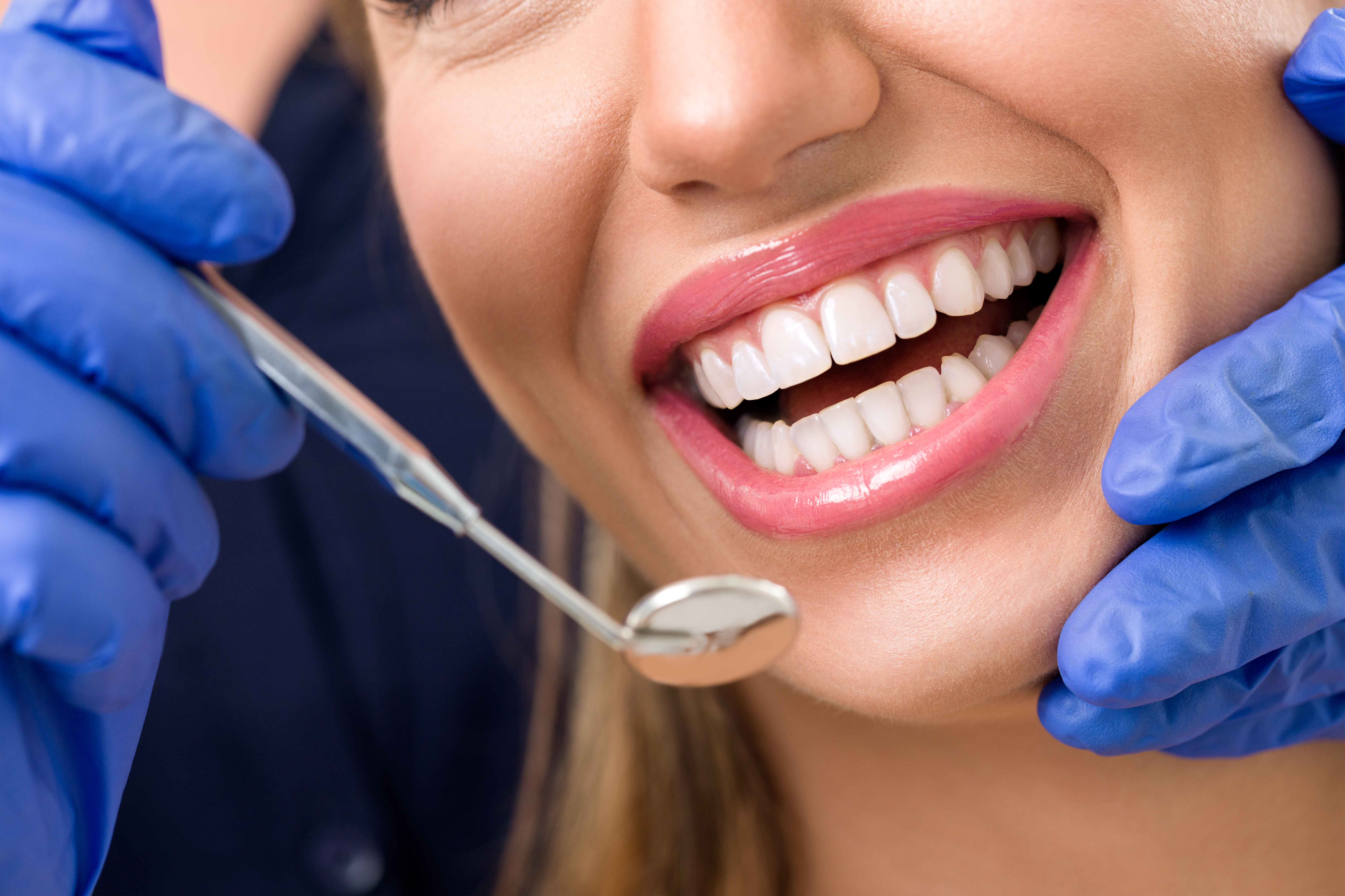 Smiling woman at dentist during oral inspection